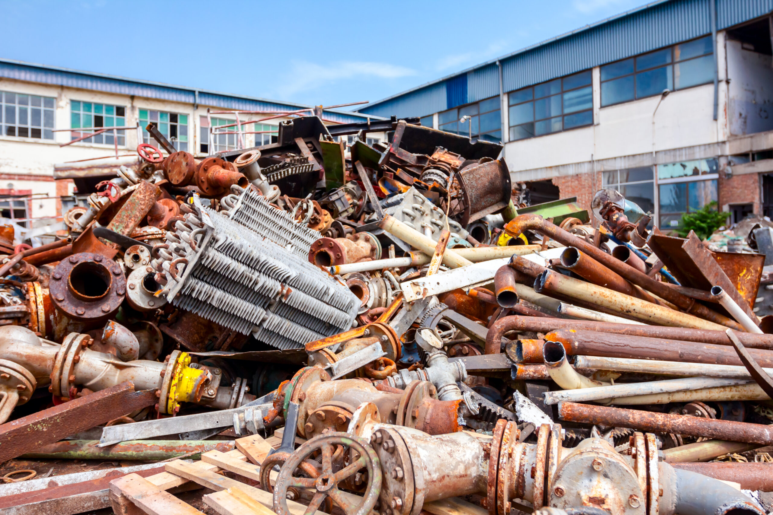Pile of scrap metal, old cooling system and industrial parts, pipes and valves after cassation.